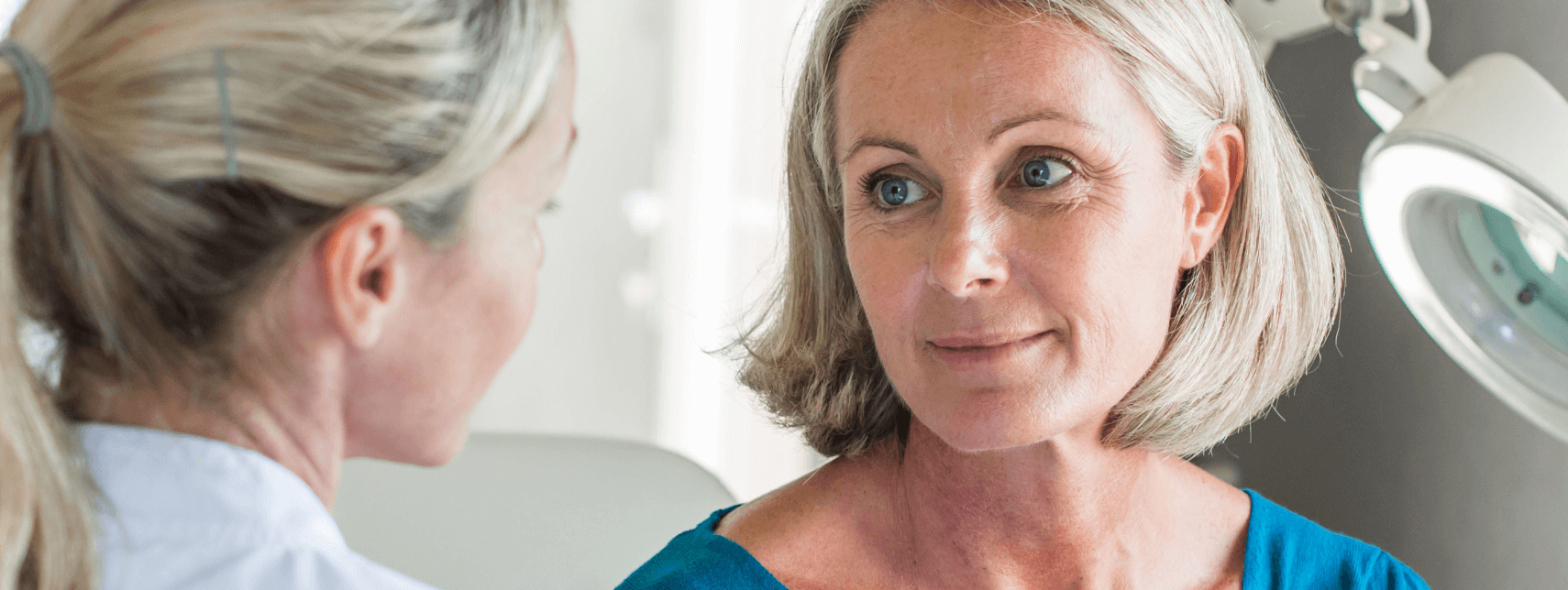A mature woman having a consultation with a hormone therapy specialist in Los Angeles in a clinical setting.