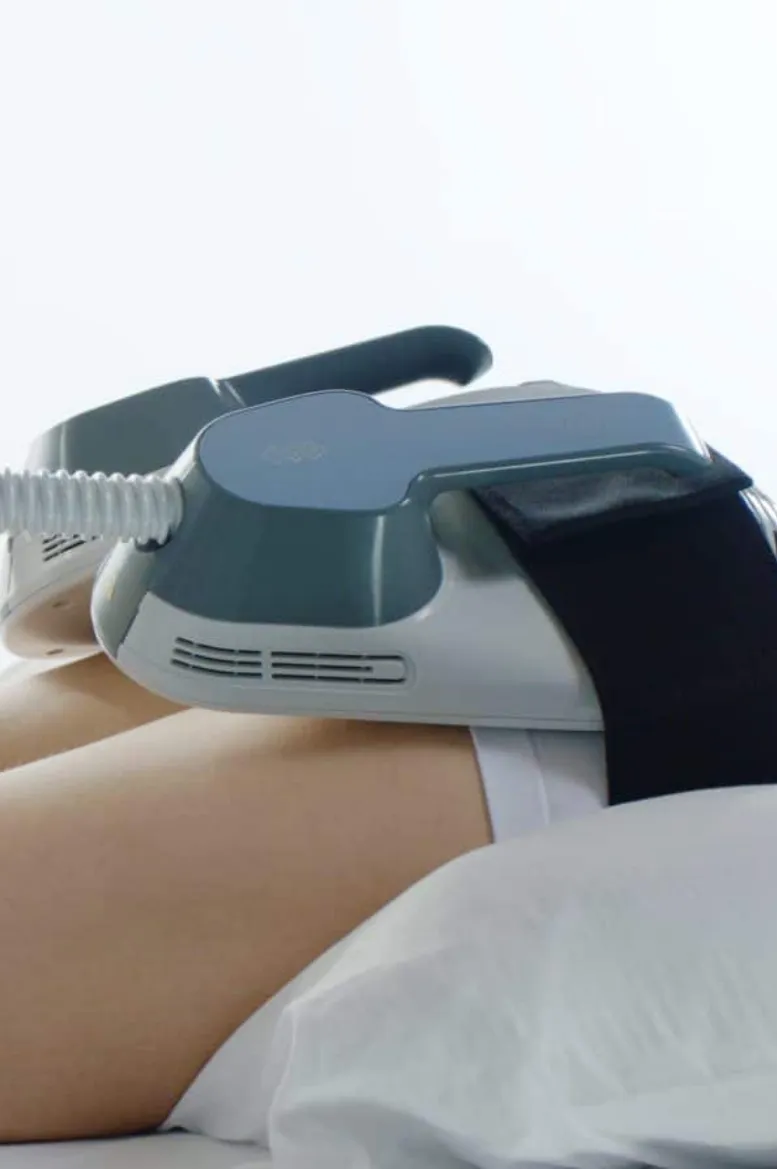 Close-up of a professional massage device being used on a person's leg by a Sexual Health Expert in Los Angeles to provide therapeutic muscle relief.