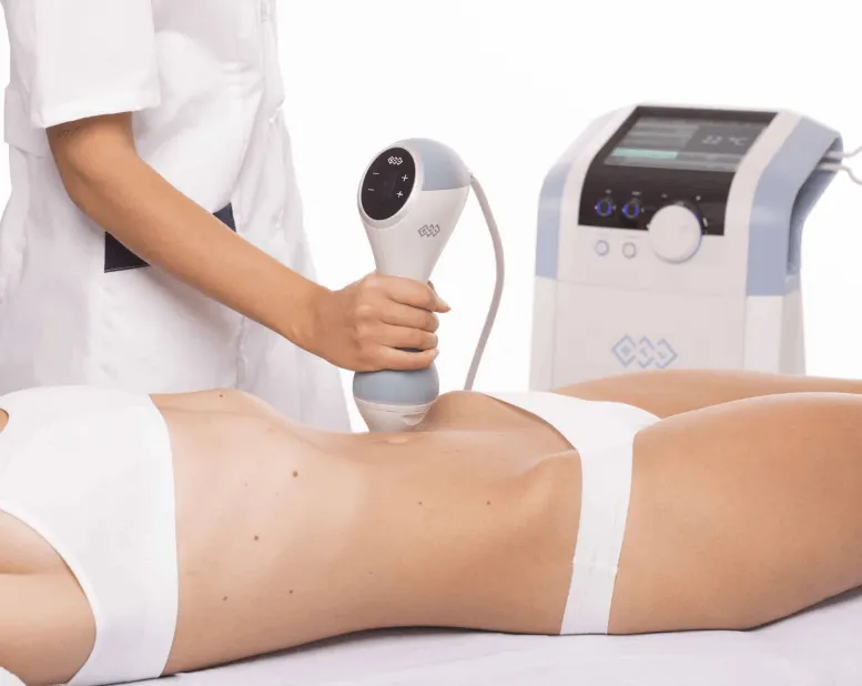 Professional sexual health treatment in Los Angeles: a specialist conducting a body contouring procedure using a modern non-invasive device.