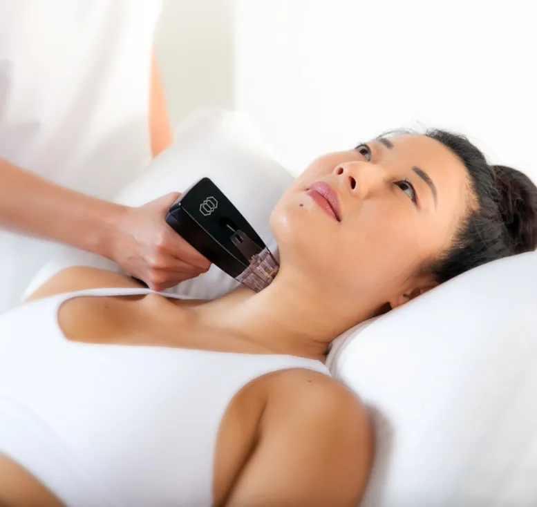 Woman receiving an ultrasound treatment on her neck at a medical or beauty clinic supervised by a Sexual Health Expert in Los Angeles.