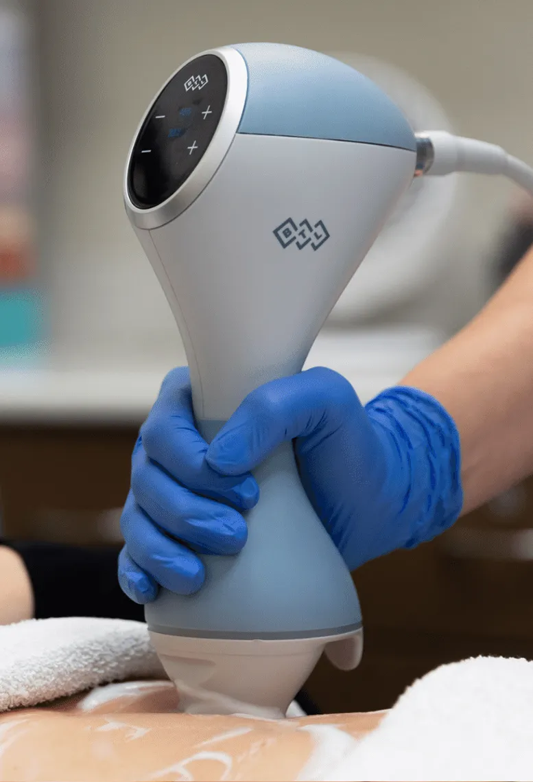 A sexual health expert in Los Angeles using a modern hand-held laser device for a cosmetic skin treatment.