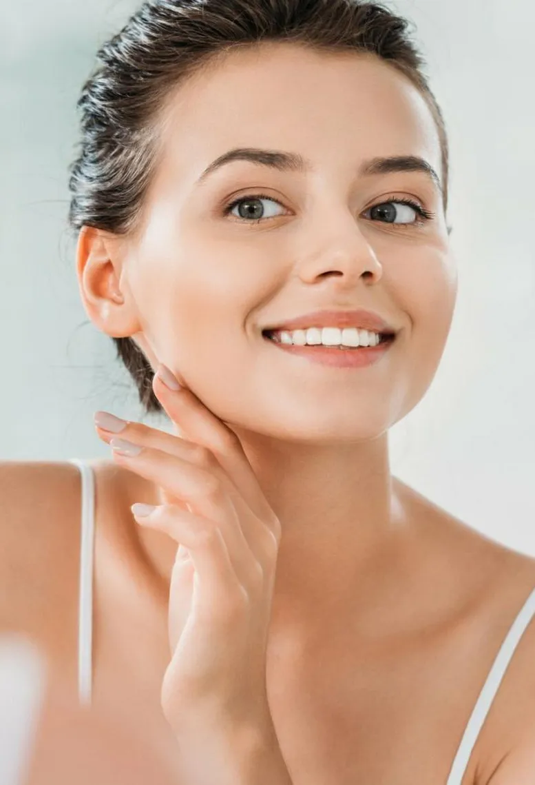 A radiant young woman with a fresh, clear complexion and a bright smile, exuding natural beauty and confidence as a Sexual Health Expert in Los Angeles.